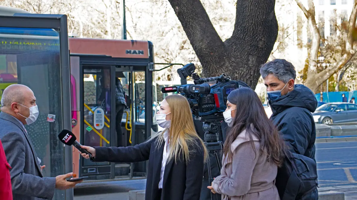 Journalists conduct a street interview in ankara capturi