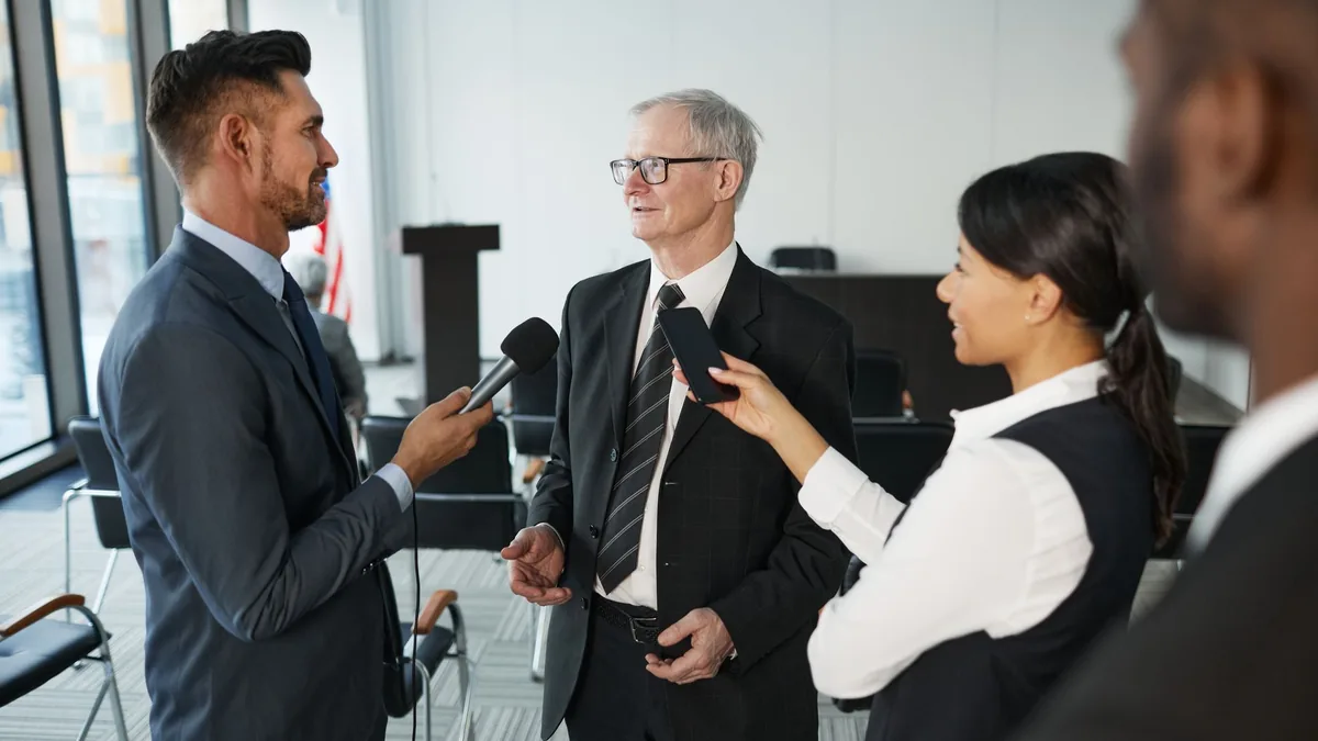 Journalists conduct an interview with a senior executive