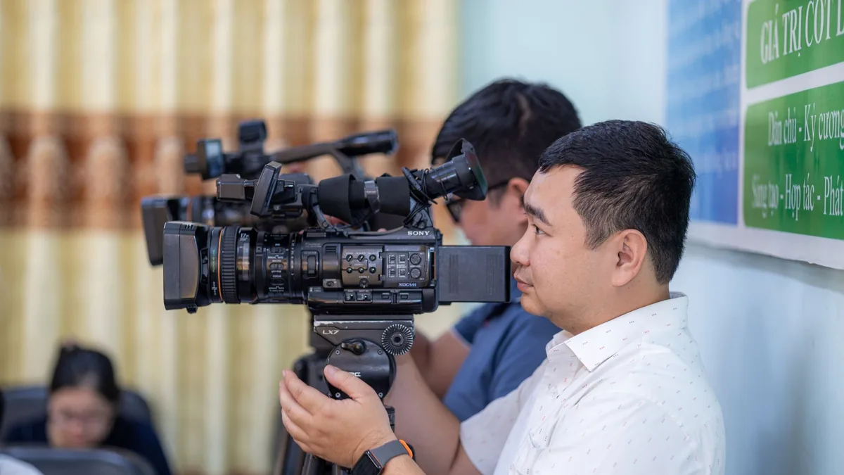 Male cameraman operating a professional video camera dur
