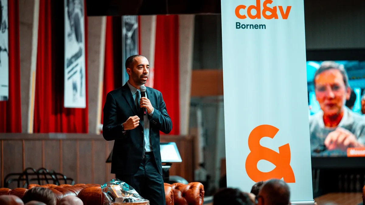 Male speaker presenting at a corporate event audiences a