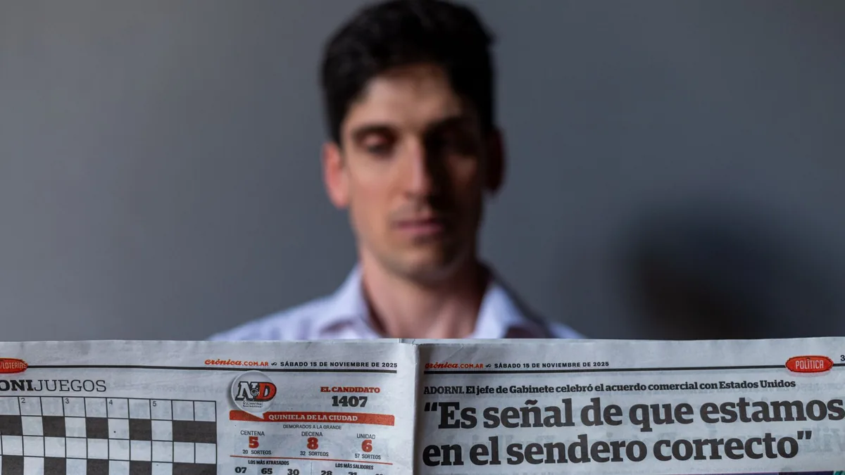 Man holding a spanish newspaper with headline and date v