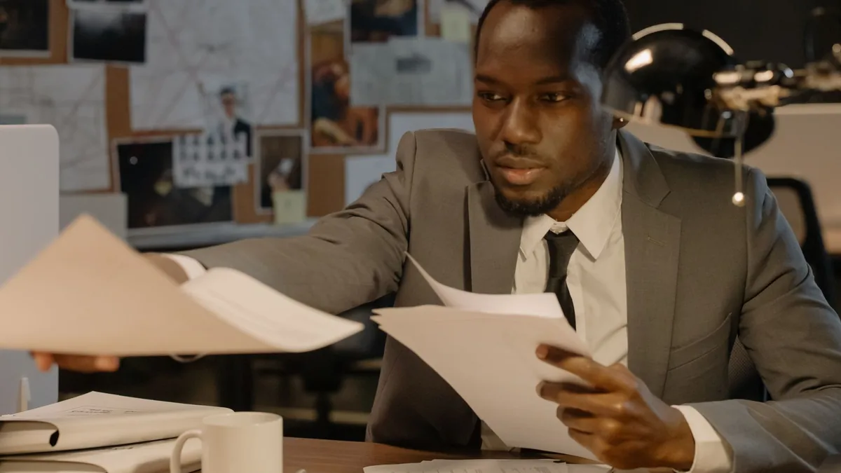 Man in a business suit working with documents at a desk