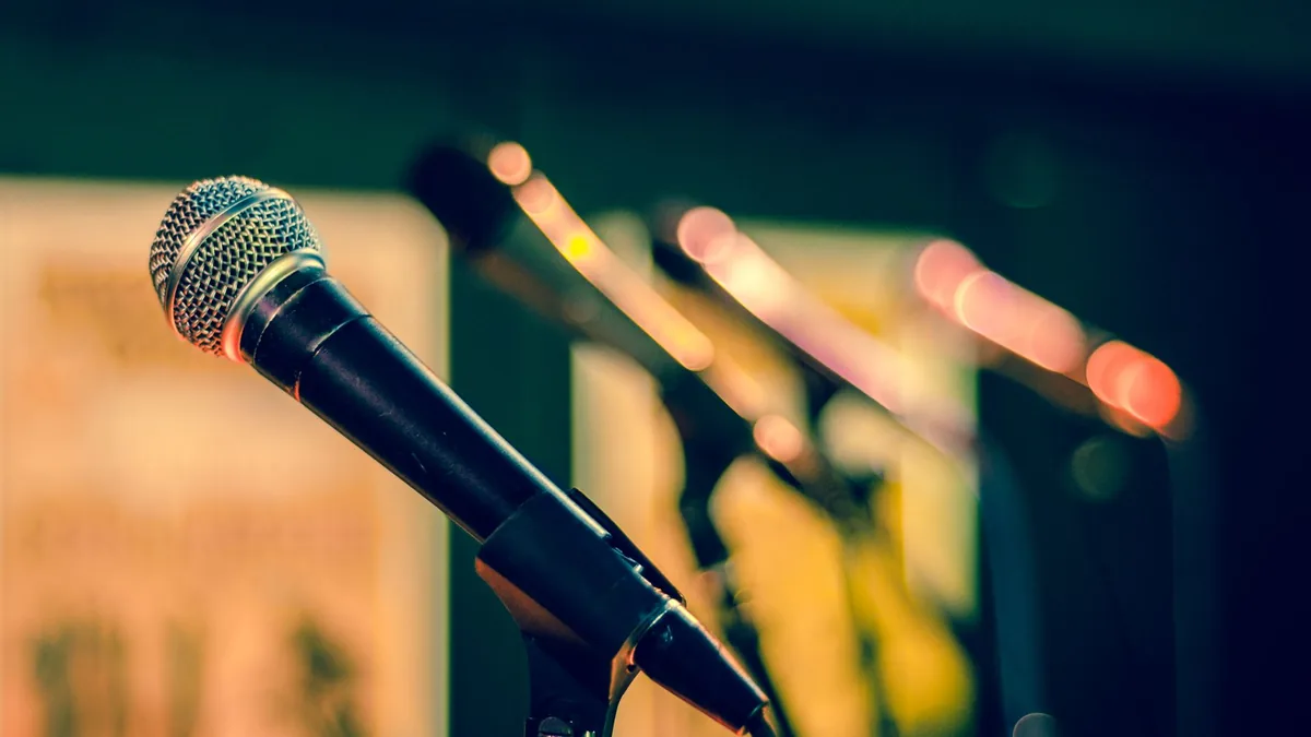 Microphones in focus with colorful blurred background id