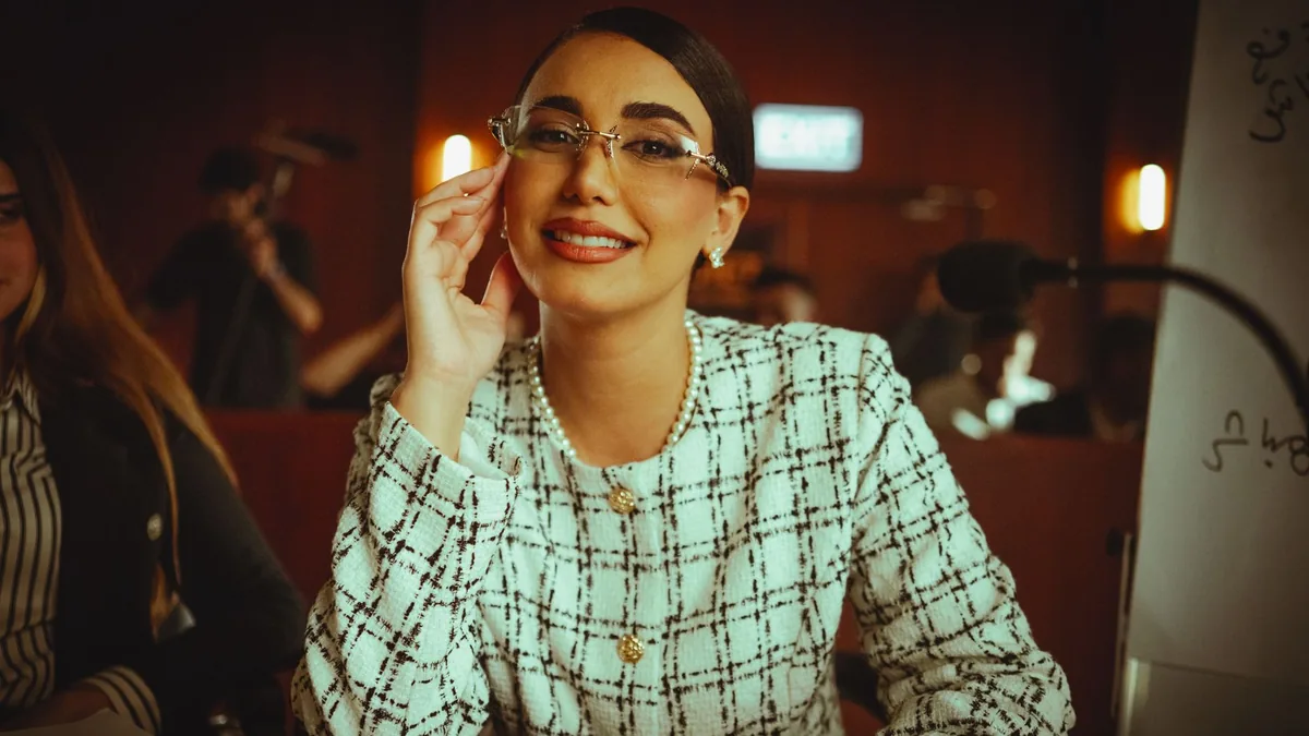 Middle eastern woman smiling confidently during a confer