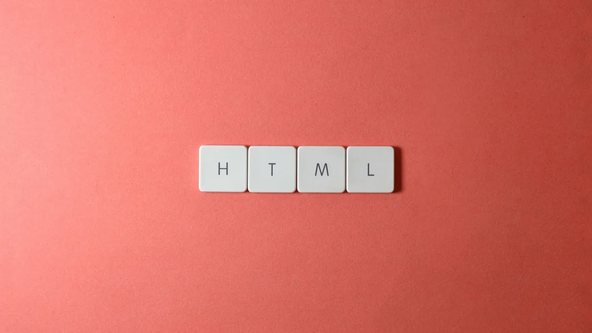Minimalist design of html letter tiles on a salmon pink
