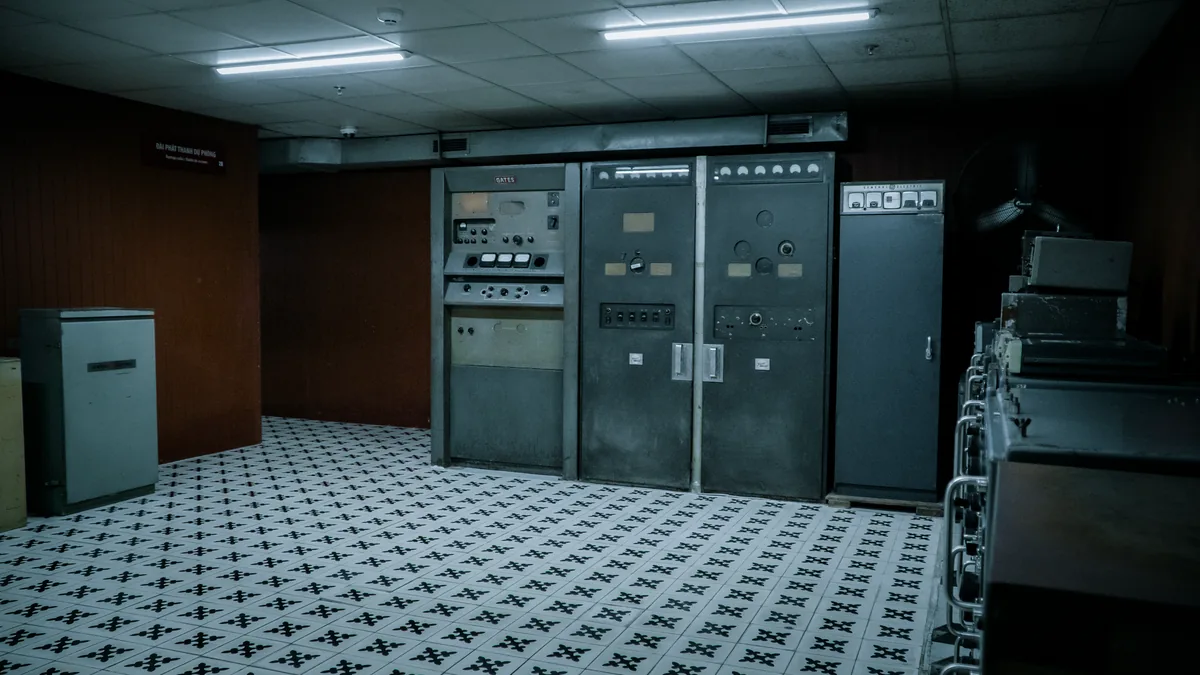 Old control room with vintage machinery and tiled floori