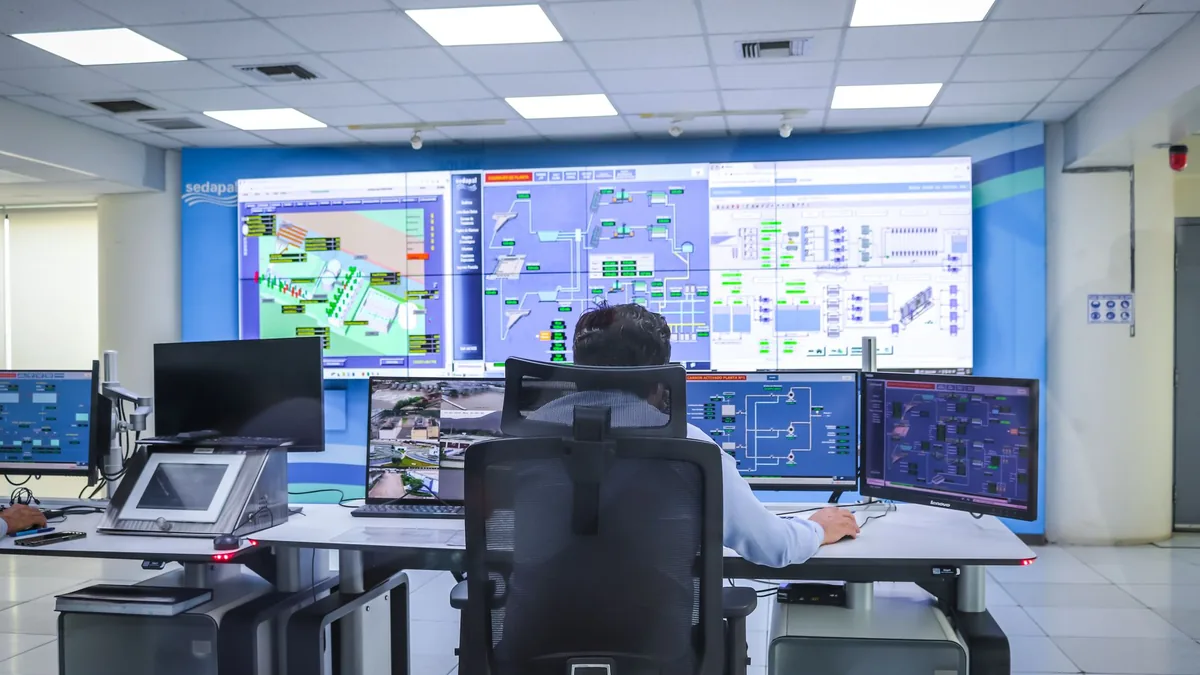 Operator in a modern control room managing technological