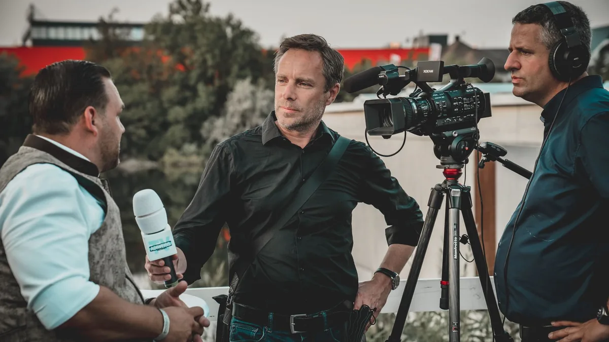 Outdoor interview with a professional news crew capturin