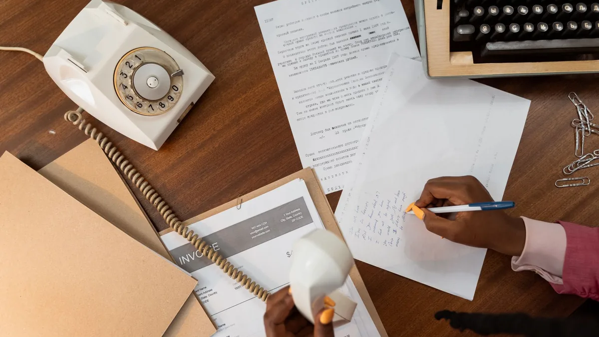 Overhead view of a person writing notes while holding a