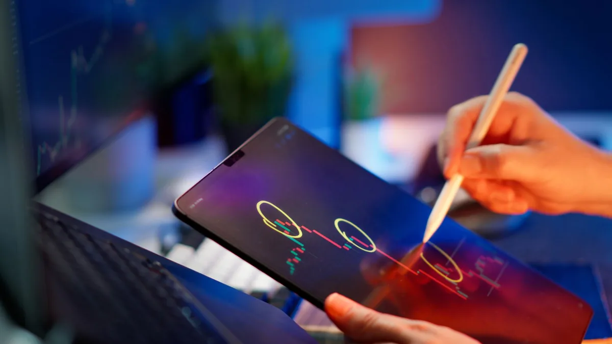 Person analyzing cryptocurrency trends on a tablet with