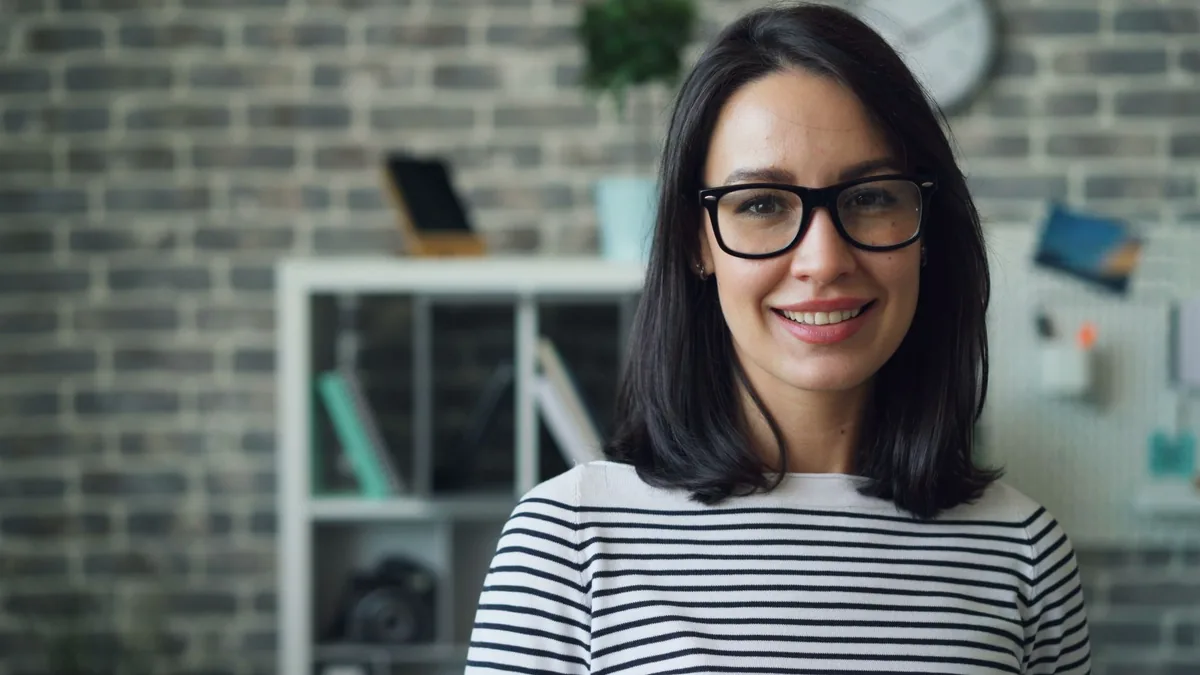 Portrait of a smiling woman with glasses in a stylish mo