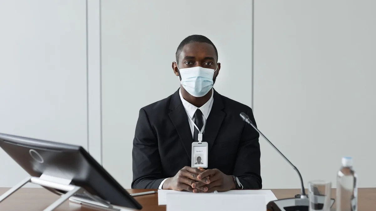 Professional african american man wearing a mask and sui