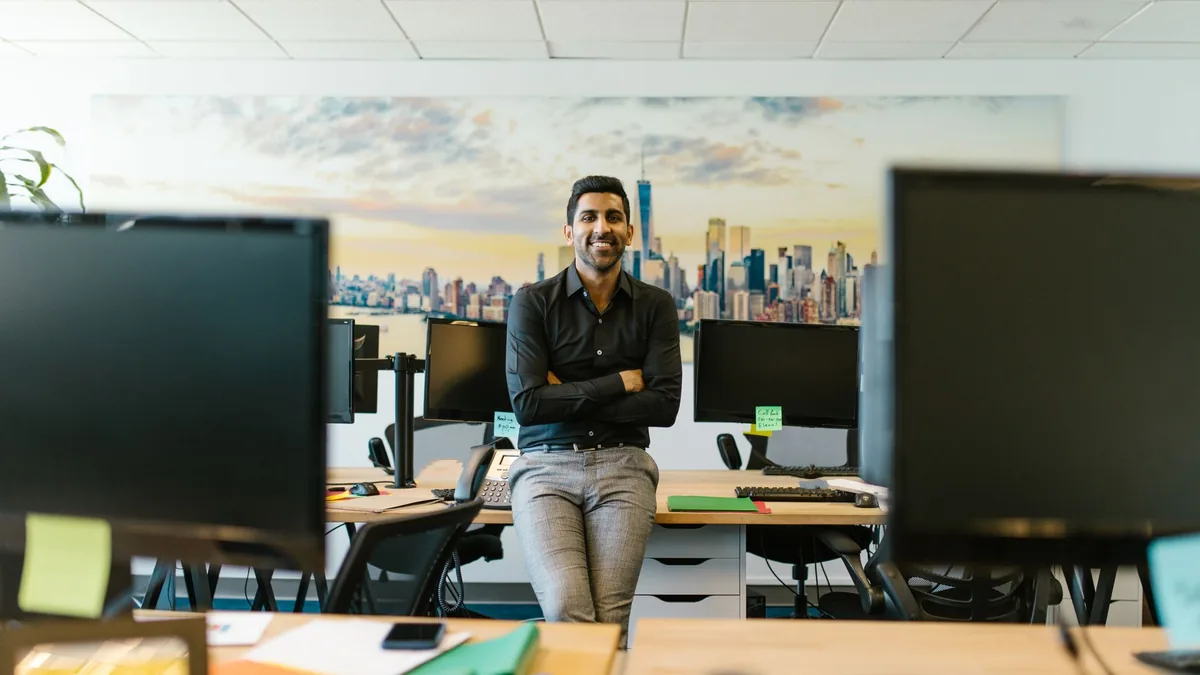 Professional businessman smiling in a contemporary offic