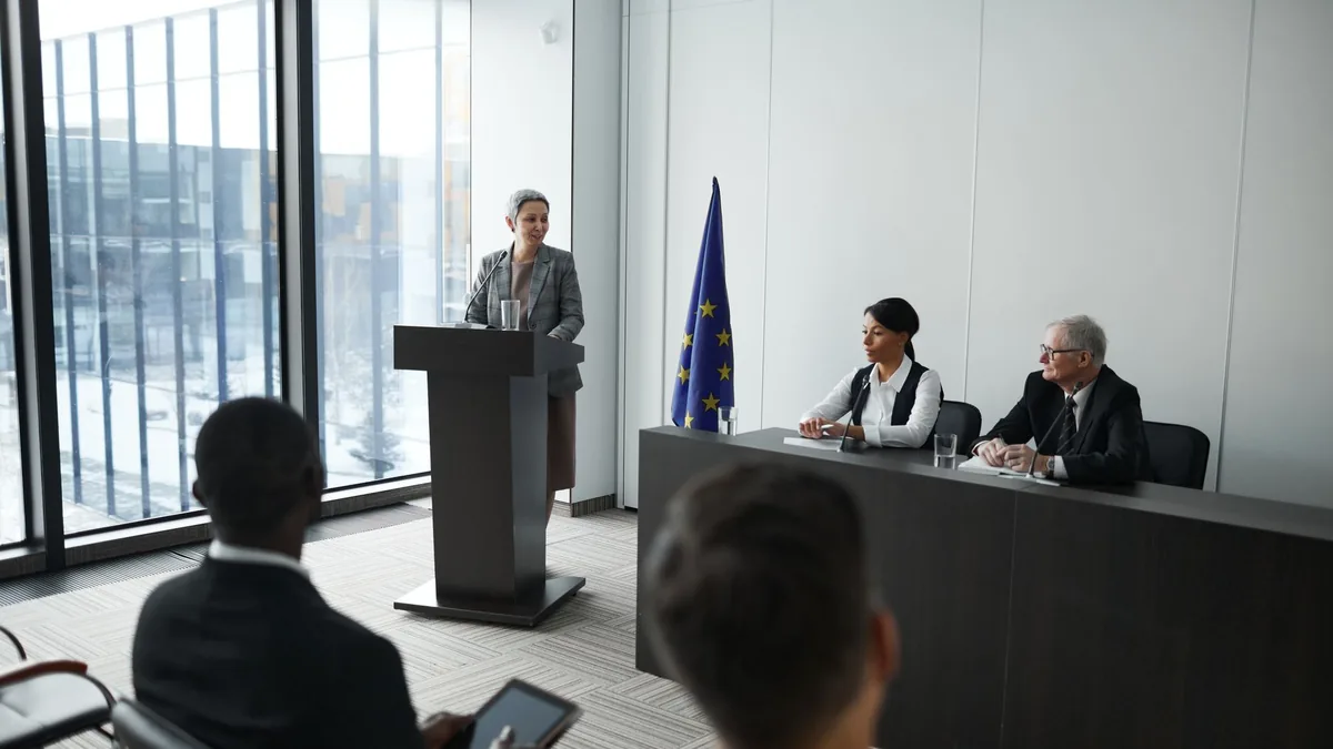 Professional conference setting with a speaker at a podi