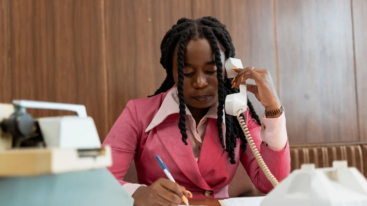 Professional woman in 80s style business attire making n