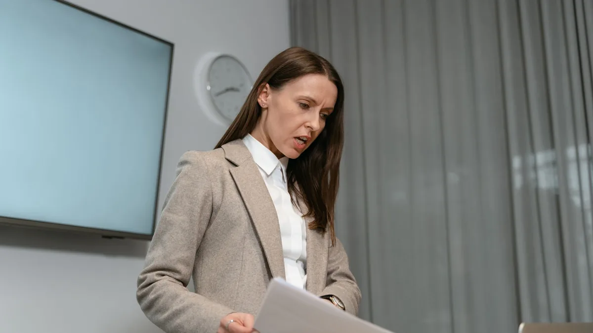 Professional woman in business attire reviewing document