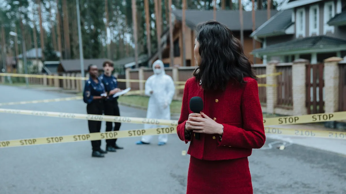 Reporter at a crime scene with police and forensic exper