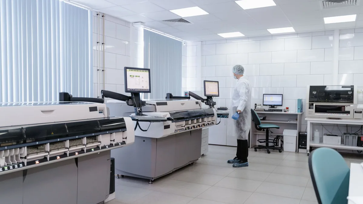 Scientist in a modern laboratory analyzing data on advan