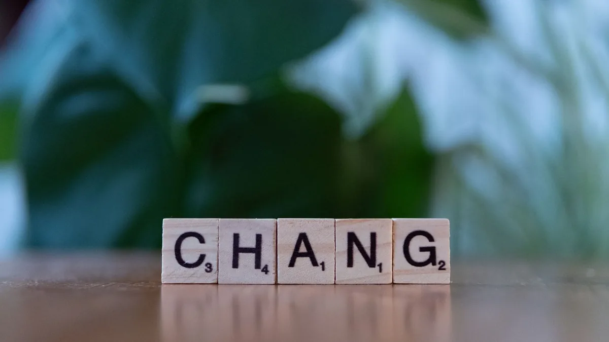 Scrabble letter tiles spelling chang on a wooden surface