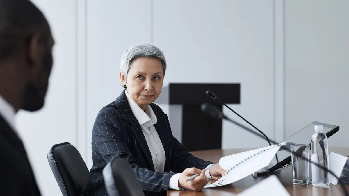 Senior businesswoman leading a conference discussion wit