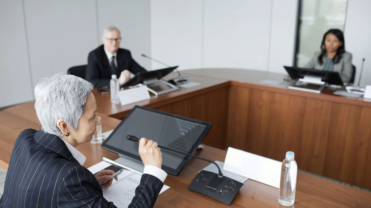 Senior executives discussing strategies in a modern boar