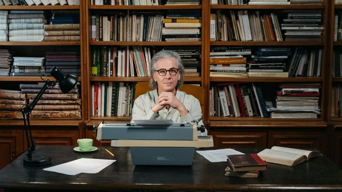 Senior man with typewriter in library embodying wisdom a