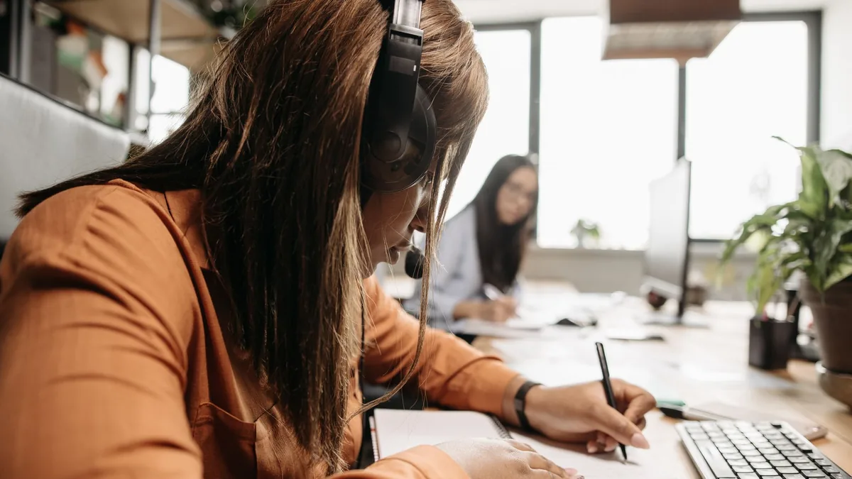 Side view of a dedicated businesswoman with headphones w