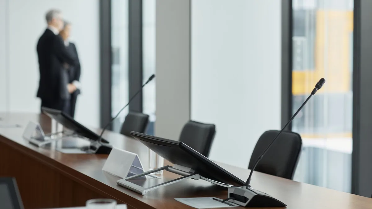 Sleek conference room setup with microphones digital dis