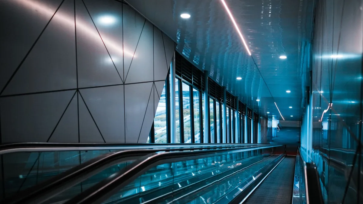 Sleek escalator in a modern glass lined airport terminal