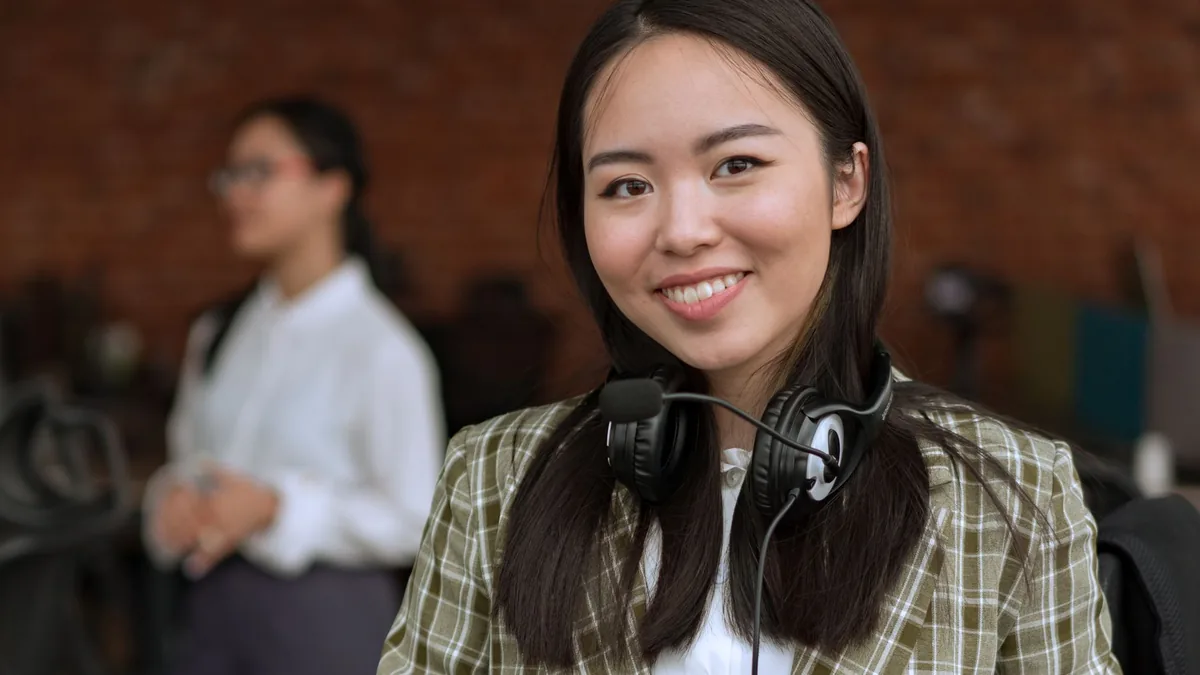 Smiling professional woman wearing a headset in an offic