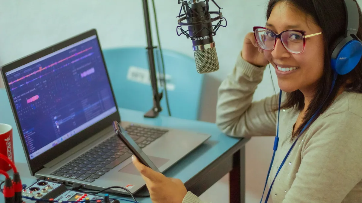 Smiling woman podcasting with professional microphone an
