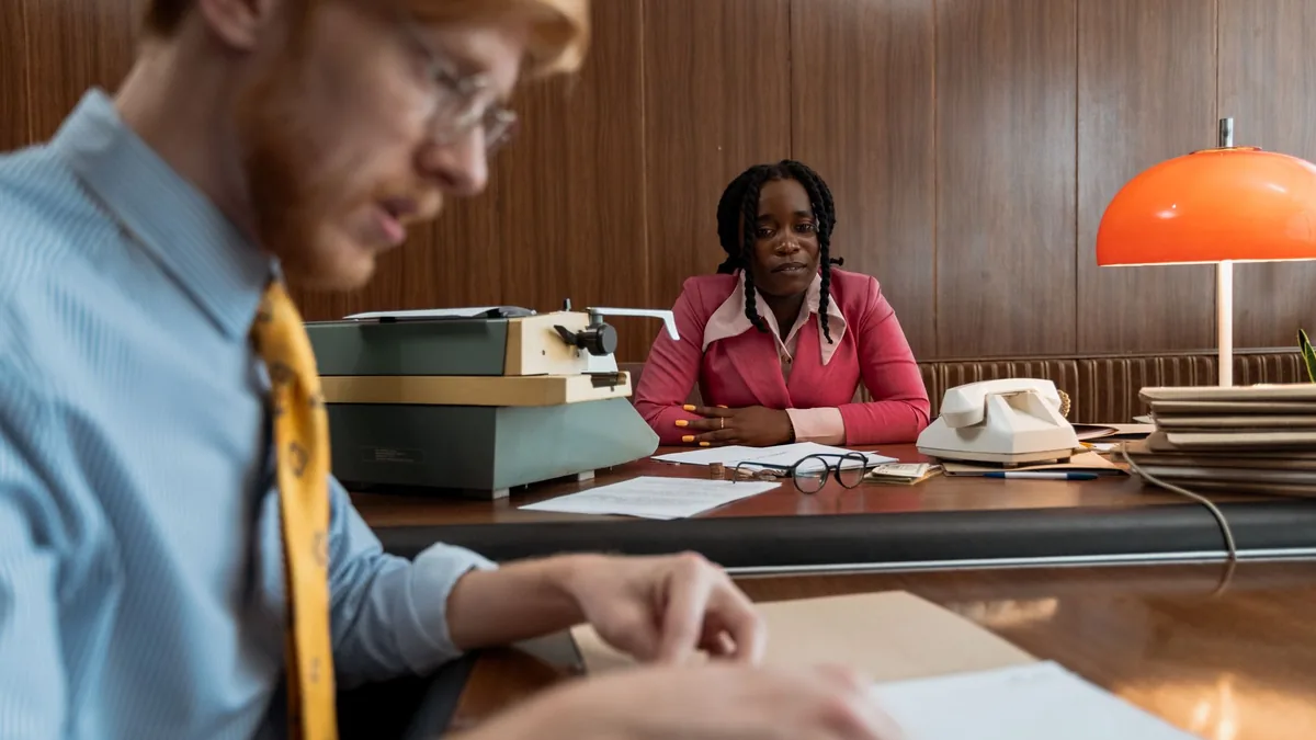 Two business professionals working in a vintage office s