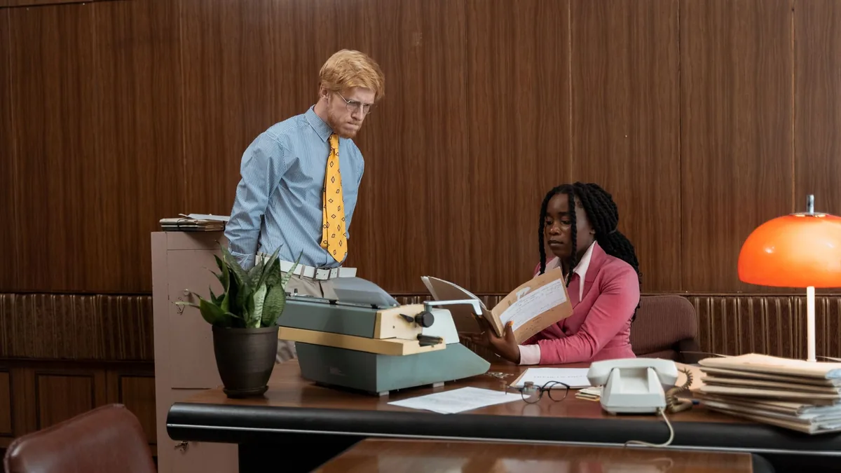 Two professionals in a classic vintage office setting wi