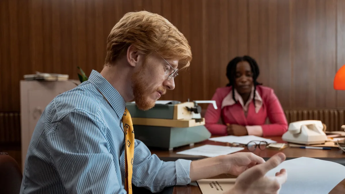 Two professionals review documents at a vintage style of