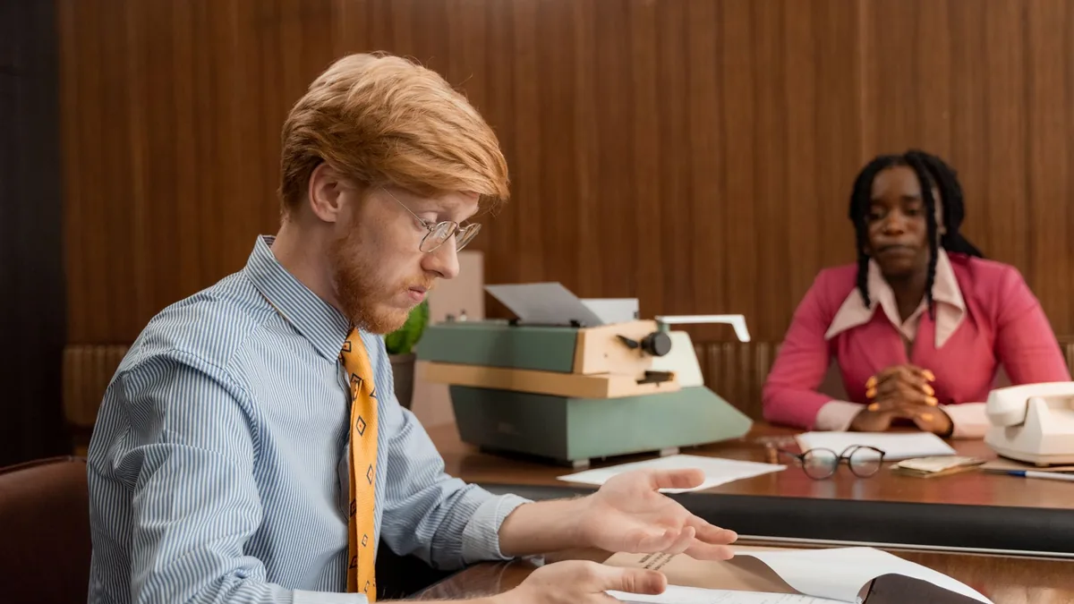 Two professionals working at a vintage desk showcasing a