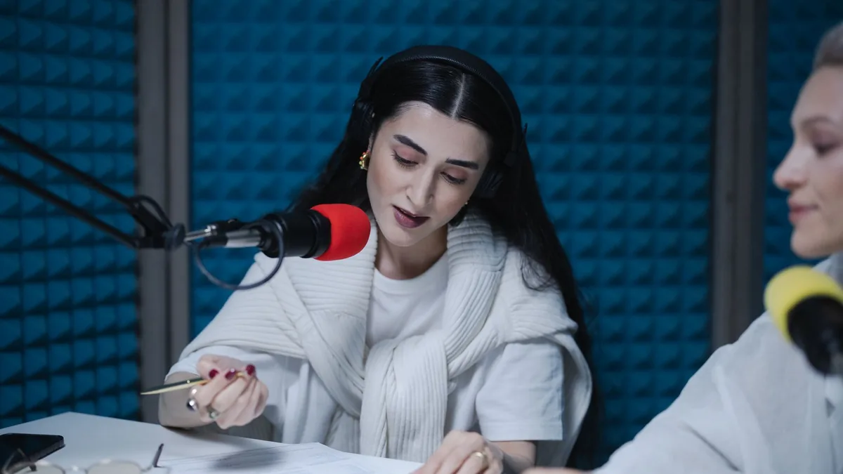 Two women hosting a radio show using professional microp