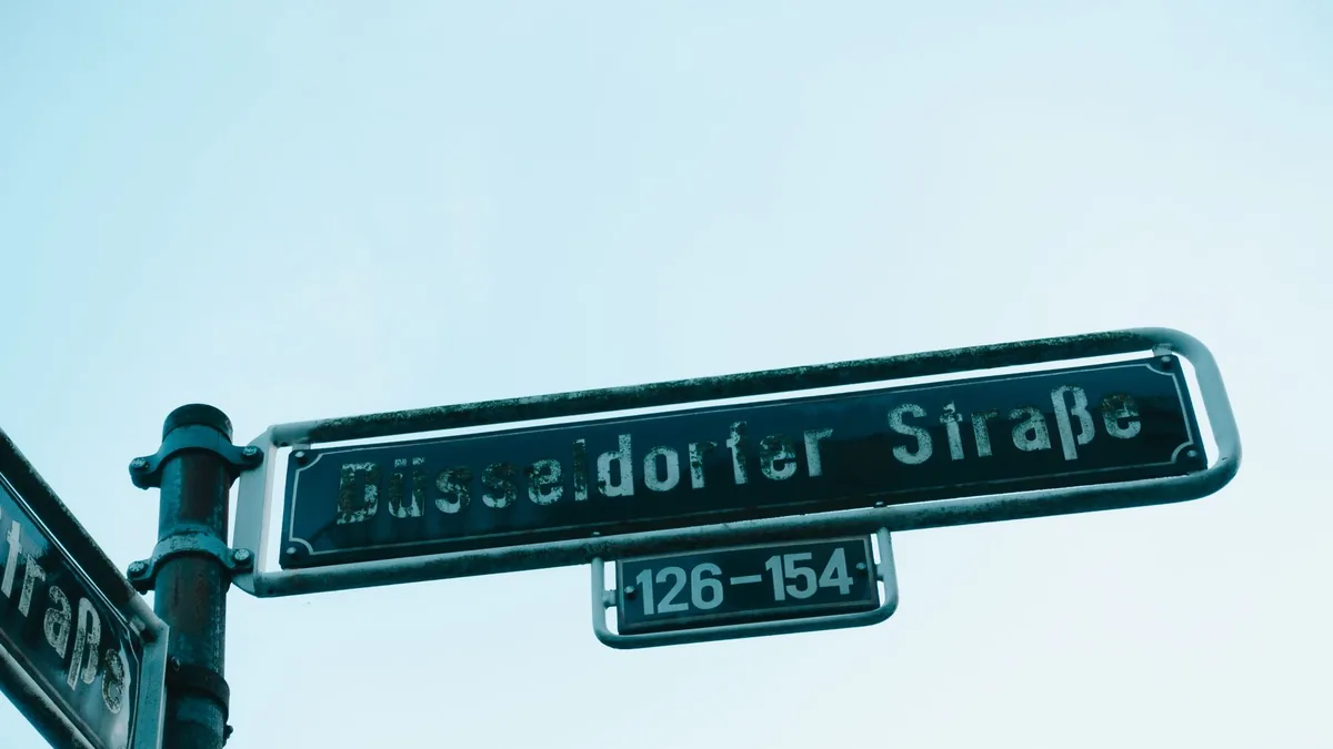 Urban street sign displaying d sseldorf stra e in german