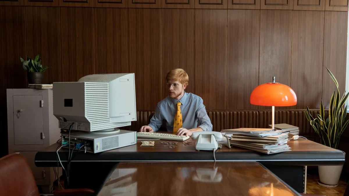 Vintage office environment with a man working on a class