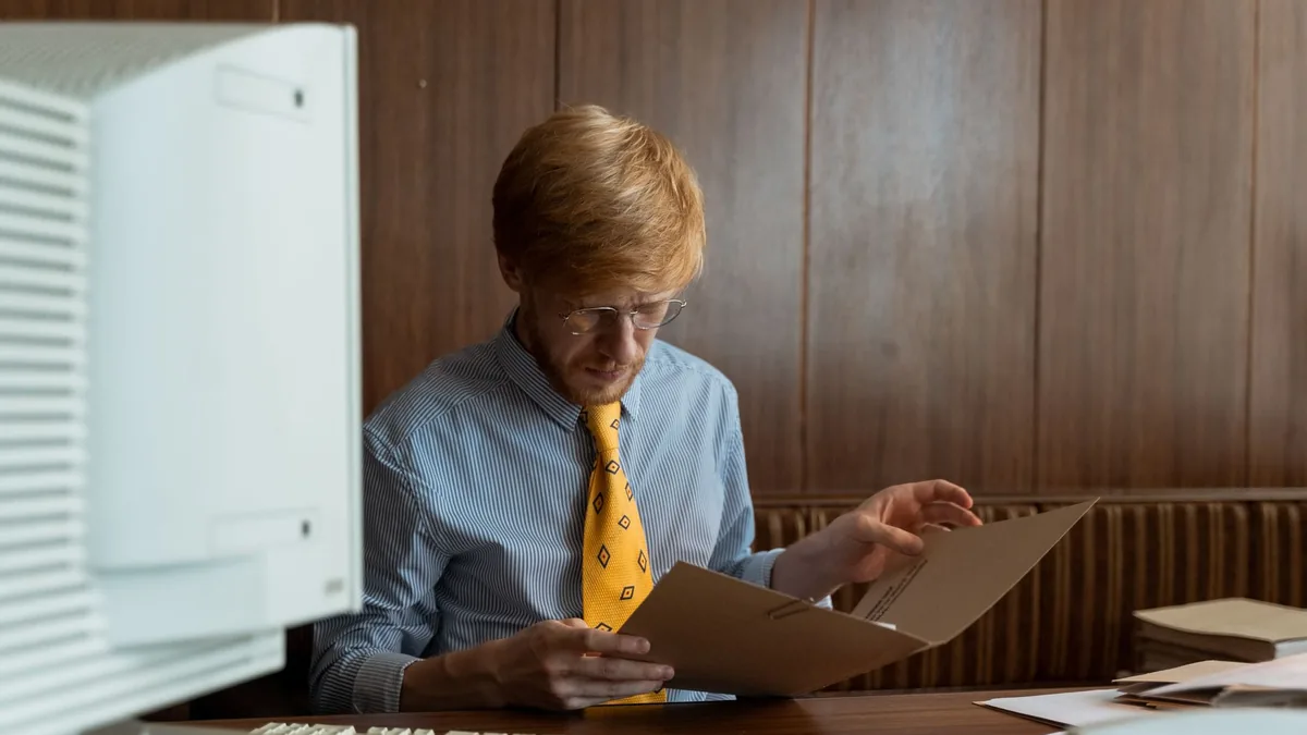 Vintage office scene with a man reviewing documents on a
