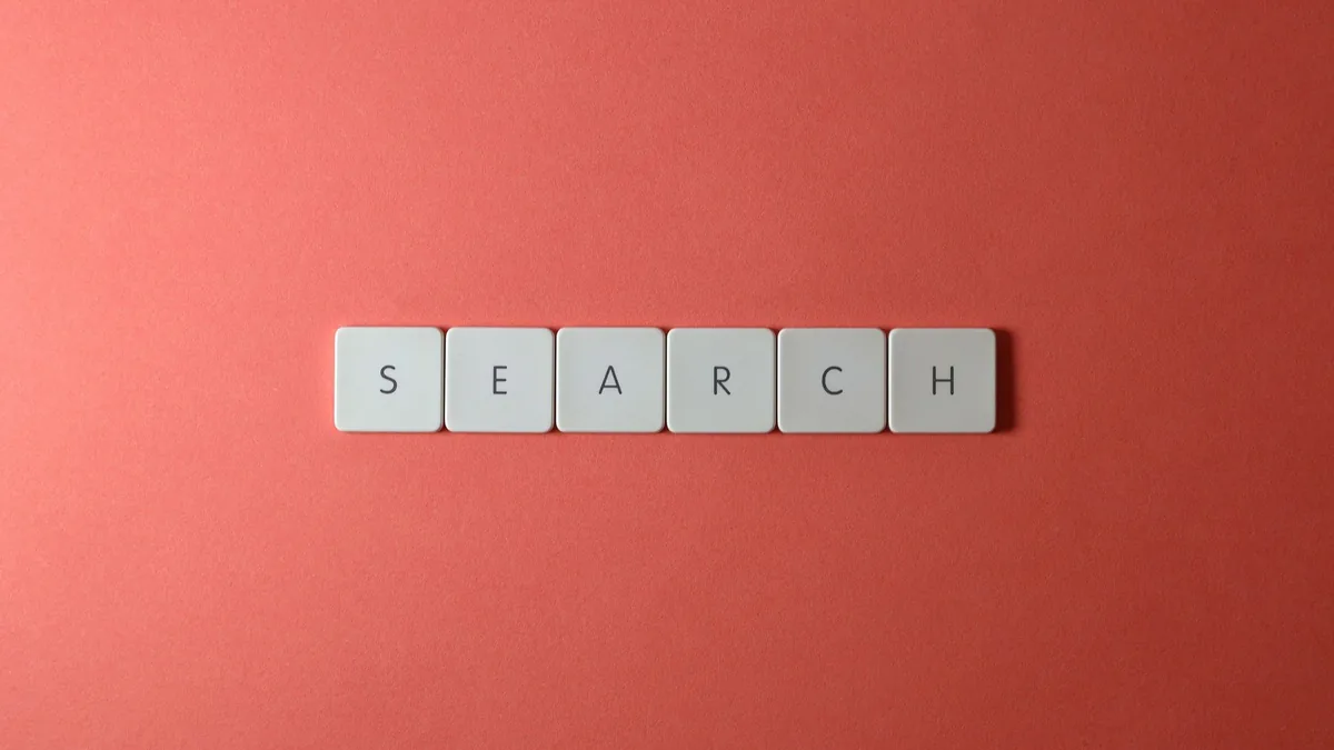 White keyboard keys spelling search on a bold red surfac