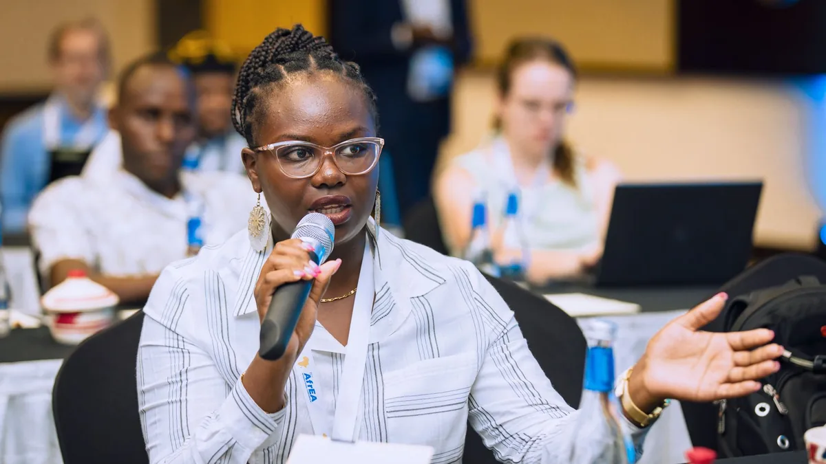 Woman speaking into a microphone during a business confe