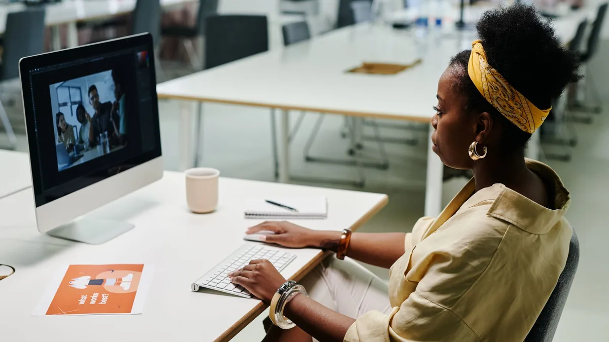 Young black woman using computer for video editing in a
